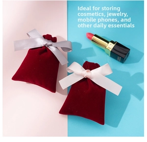 Detail of red velvet drawstring pouches with satin bows for jewelry and cosmetics storage