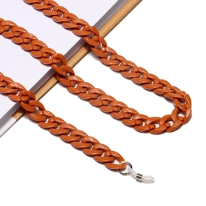 Catenina per occhiali spessa in acrilico ambra arancio su libri bianchi