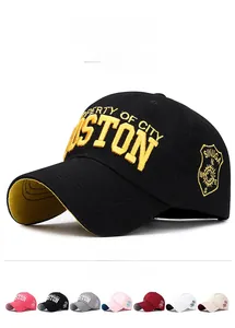 Detailed view of black baseball cap with yellow Boston embroidery and multi-color options