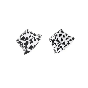 Summer cow print bucket hat with black and white spots for sun protection and style