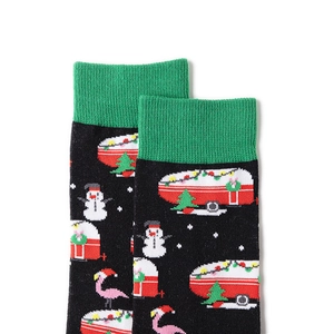 Detailed knit pattern on festive black socks with snowman and camper embroidery
