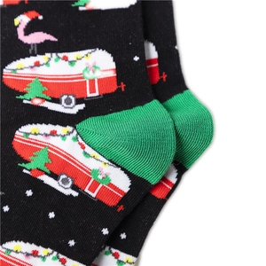 Close-up of knitted cotton Christmas socks featuring RV, flamingo, and tree patterns