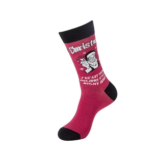 Detail of red Christmas sock featuring Santa Claus pattern and festive English typography