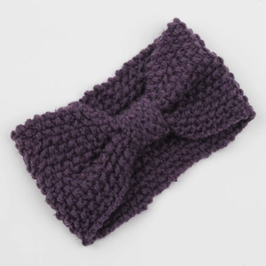 Detail of purple chunky knit headband featuring bohemian texture and bow knot style