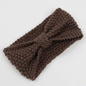 Close-up of thick corn kernel knit texture and twist knot on dark brown winter headband