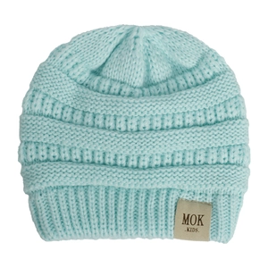 Close-up of mint blue knitted baby beanie showing the MOK KIDS leather patch detail