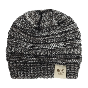 Detail of the chunky knit texture and MOK logo patch on the baby winter beanie hat