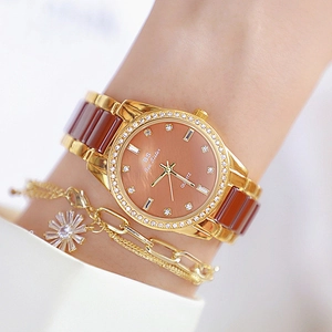 Women's gold and brown ceramic quartz watch with sparkling crystal bezel and flower charm