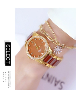 Close-up of elegant women's watch with crystal bezel and matching daisy charm bracelet