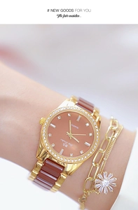 Close-up of a ladies' gold watch and floral zircon bracelet on a woman's wrist