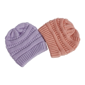 Detailed close-up showing thick ribbed knit texture of purple and pink winter hats
