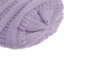 Detail of light purple knitted baby hat showing ribbed texture and top stitching