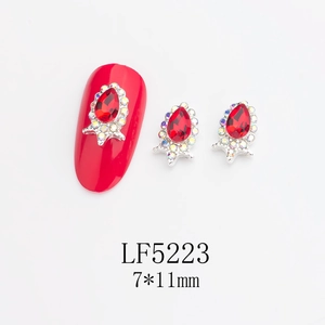 Detailed view of red teardrop nail art rhinestones in silver alloy with 7x11mm dimensions