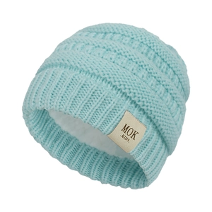 Detail of light blue knit baby hat with warm fleece lining and MOK KIDS textile label