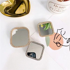 Detail shot of square rhinestone-rimmed phone mirrors in gold and silver finishes