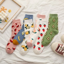 Detailed flat lay of cotton socks with embroidered watermelon, banana, and strawberry patterns