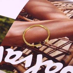 Detailed macro view of gold-plated silver ring featuring two square zirconia stones
