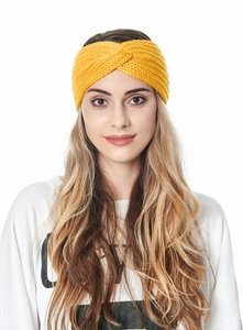 Detailed knit texture of a yellow twisted headband for women shown on a model head