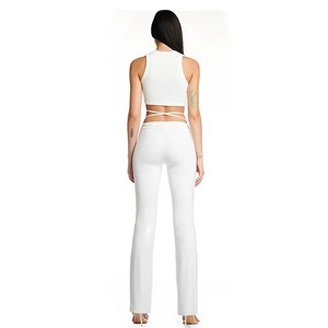 Detail of white backless jumpsuit with wrap-around waist ties and flared pants
