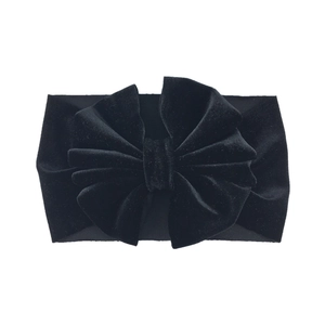Close-up of a premium black velvet oversized bow headband for babies and toddlers