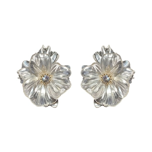 Elegant silver flower stud earrings with sparkling crystal centers in a minimalist style