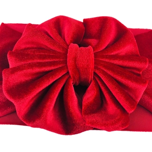 Macro shot of red velvet oversized multi-layer bow headband for baby girls accessory