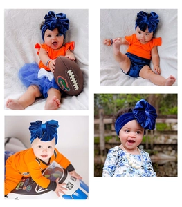 Detail of baby velvet headband with oversized bow and matching floral outfit sets