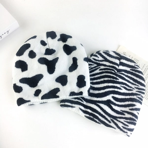 Winter knit beanies featuring cow and zebra patterns in soft velvet-like fabric