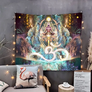 Detail of meditation tapestry with Om symbol and warm string lights on gray wall