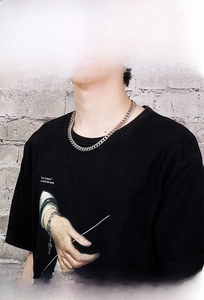 Classic silver Cuban link chain necklace for men styled on a casual black t-shirt