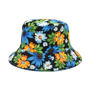 Close-up of floral daisy print on black cotton bucket hat with vivid petal details