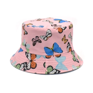Close-up of pink bucket hat featuring colorful butterfly prints on canvas fabric