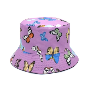 Close-up detail of purple bucket hat featuring colorful butterfly prints and stitched brim