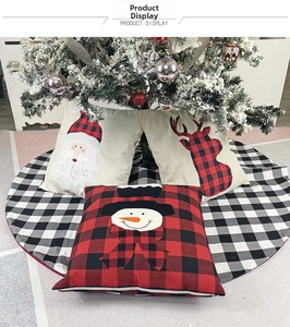 Detail of Christmas pillow covers and tree skirt featuring plaid patterns and embroidery