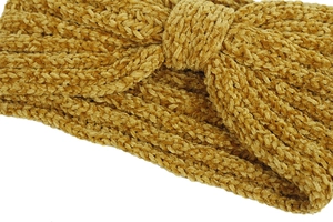 Detailed close-up of yellow chenille knit headband with knot design for winter