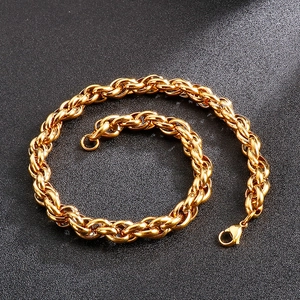 Macro view of golden stainless steel twist chain link texture and lobster clasp detail