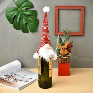 Red knit Christmas gnome wine bottle cover with snowflake pattern and white beard