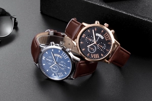 Detail view of quartz watches with leather straps, three-dial design and calendar window