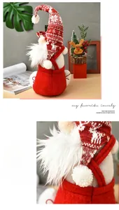 Detail of red and white knitted Christmas gnome wine bottle cover with soft beard texture