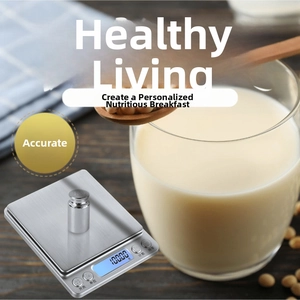 Macro shot of digital kitchen scale with stainless steel platform and blue backlit LCD screen