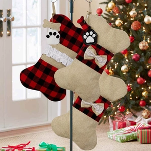 Detail of burlap dog bone Christmas stockings with plaid bows and paw prints decor