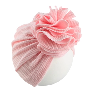 Detailed side view of pink baby turban hat with layered ruffle flower and ribbed texture