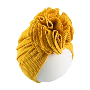 Detailed view of yellow waffle fabric baby turban with a large 3D sunflower design