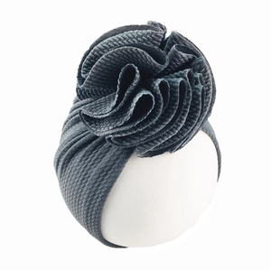 Detail of baby headband with a large 3D flower decoration in dark grey knit fabric
