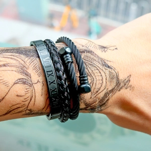 Three-piece black stainless steel bracelet set with roman numerals and woven textures