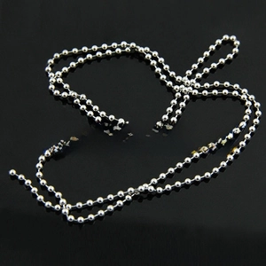Detail of silver stainless steel ball chain with connector clasp on black background
