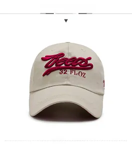 Macro view of beige baseball cap featuring red 3D embroidery and twill cotton texture