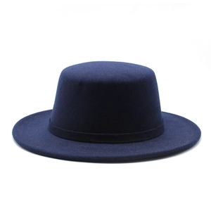Detail of dark blue wool felt flat top hat featuring a matching minimalist decorative band