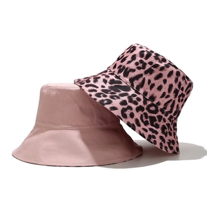 Detail of reversible pink leopard print and solid cotton bucket hat set for women