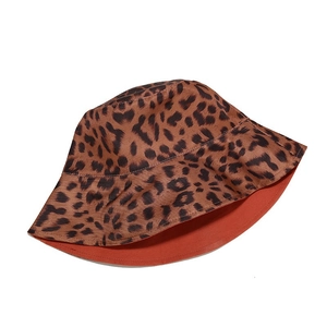 Close-up of reversible leopard print bucket hat with orange lining and cotton texture